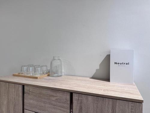 a wooden table with glasses and a box on it at Comfy Damansara PJ Condo 3BR 2Carpark in Petaling Jaya