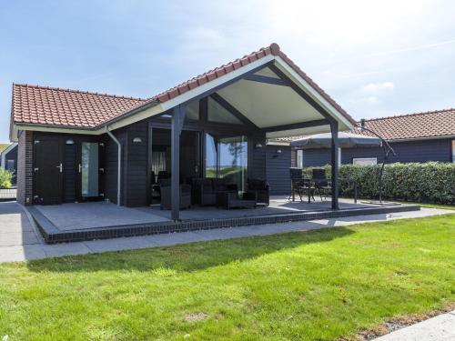 a patio with awning on a house at Relaxing Home Close to Diving Spots in Kattendijke
