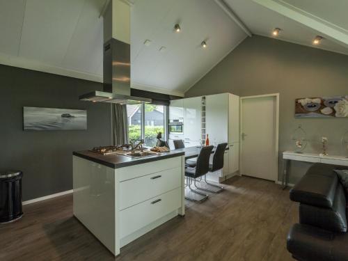 a kitchen and living room with a sink and a counter at Relaxing Home Close to Diving Spots in Kattendijke