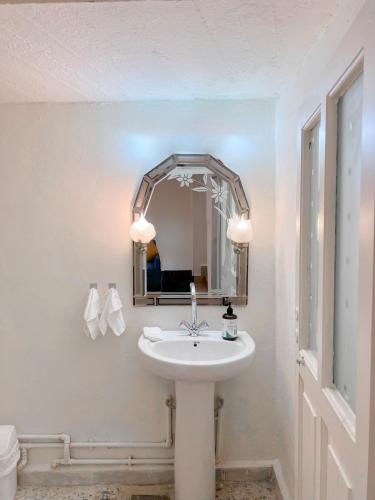 a bathroom with a white sink and a mirror at Casa Riviera in Zahlé
