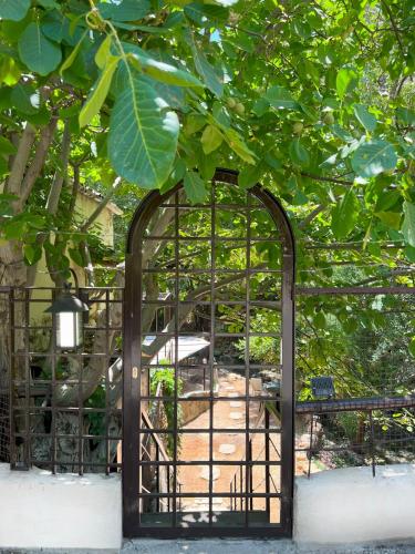 an iron gate with a garden behind it at Casa Riviera in Zahlé