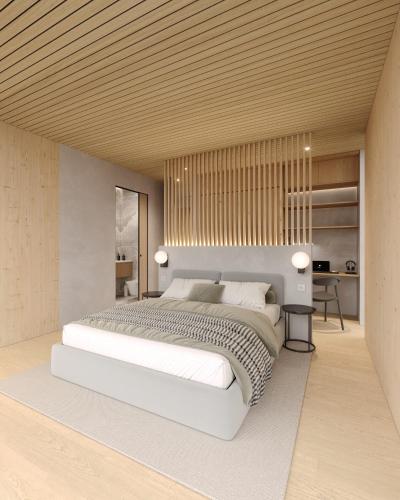 a bedroom with a large white bed and a desk at Inai Haven in Ivalo