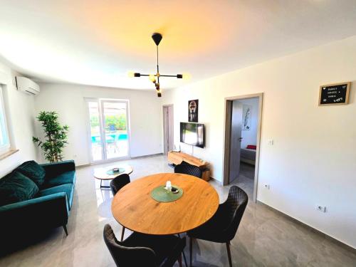 a living room with a table and a couch at Family house Hana in Kanfanar