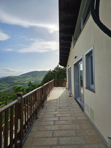 a wooden walkway next to a building with a view at La Magia Lucana in Colobraro