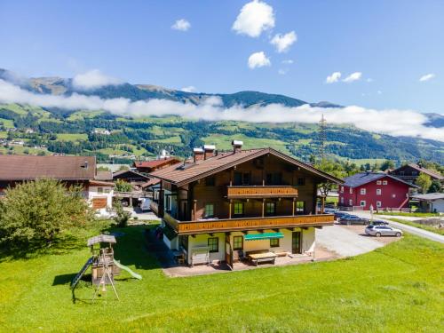 a house on a hill with a green field at Apartment Sonnberg in Mittersill