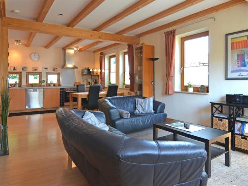 a living room with a couch and a table at Ferienwohnung im malerischen Eslohe in Eslohe