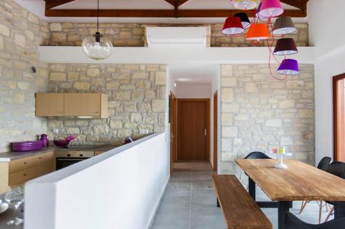 a kitchen and dining room with a wooden table at Cottage, Kyrianna in Kiriánna
