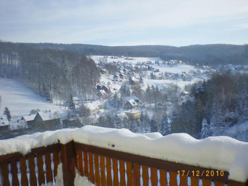 a snow covered town with houses in the distance at Cozy Ski Base with Garden in Breitenbrunn