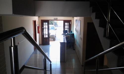 a hallway with a staircase leading to a room at Hotel Sambaquis in São Luís