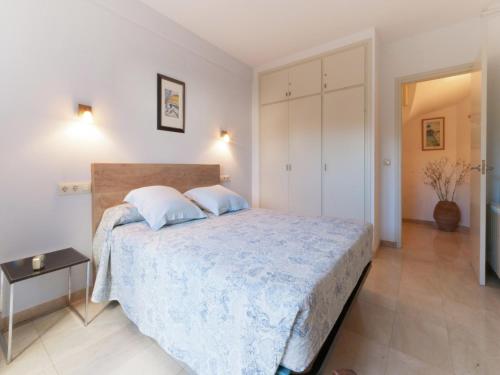a bedroom with a large bed in a room at Sunny Terrace Near Beach in L'Escala