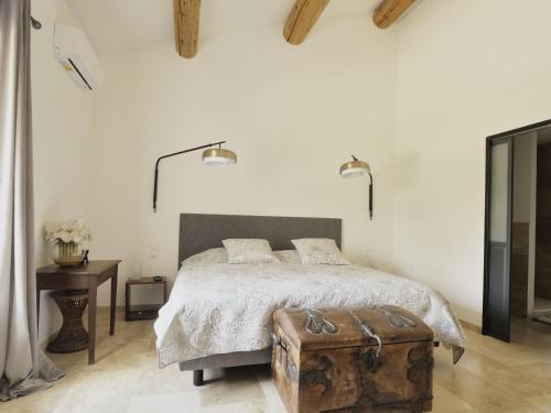 a bedroom with a bed with a trunk on it at La bambouseraie de sulauze in Miramas