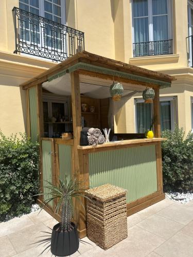 a large building with a deck with a building at Hotel Carlton in Beaulieu-sur-Mer