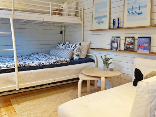 a bedroom with a bunk bed and a table at 4 person holiday home in GRISSLEHAMN-By Traum in Grisslehamn