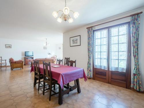 a dining room with a table with a pink table cloth at Labardamier Garden Home in Villefranche-du-Périgord