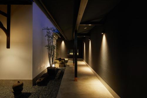 a dark hallway with lights on the wall at Enso Machiya in Kyoto