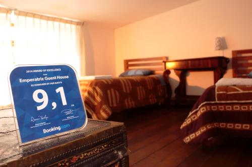 a room with a sign in front of a bedroom at Emperatriz Guest House in Cusco