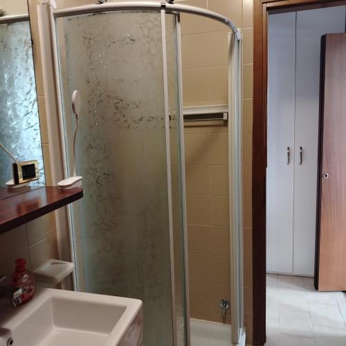 a shower with a glass door in a bathroom at Irma in Grado