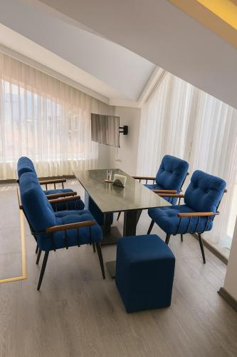 a dining room with a table and blue chairs at Reflection of the Bosphorus in Istanbul