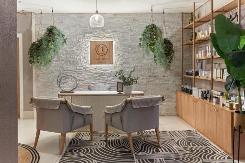 a room with a table and two chairs at Taj Cape Town in Cape Town