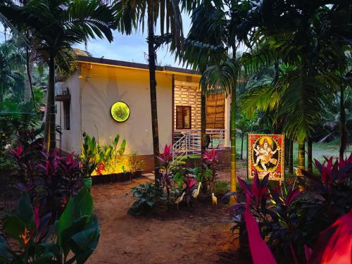 a house with a lot of plants in front of it at Areca Nest in Gokarna