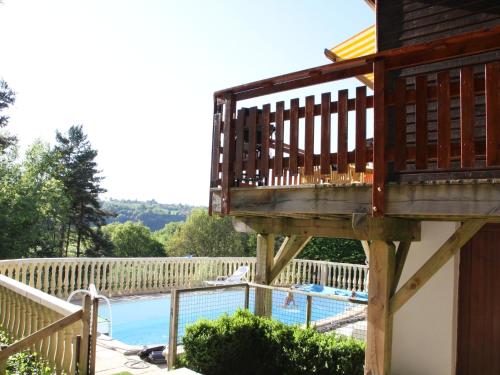 a balcony over a swimming pool on a house at Poolside Bliss Near Lake in Beaulieu