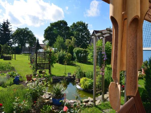 a garden with a pond in a yard at Ferienwohnung in den Hüttenroder Bergen in Hüttenrode