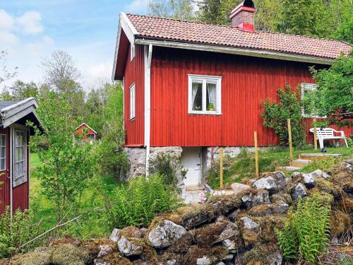 a red house with a red roof at 6 person holiday home in HENÅN in Henån