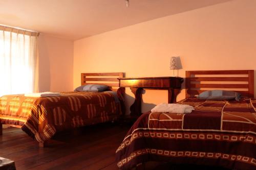 Postel nebo postele na pokoji v ubytování Emperatriz Guest House