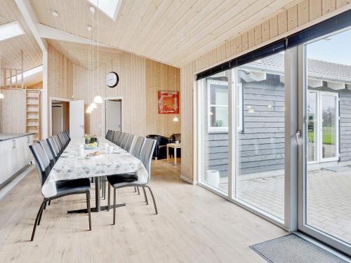 a dining room with a table and chairs at Luxury Pool Villa Marielyst - By Traum Ferienwohnungen in Marielyst
