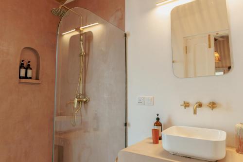 a bathroom with a shower and a sink and a mirror at 3 Bed Private Villa With Pool, 250m To The Beach in Ahangama