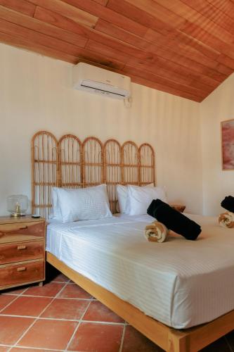a bedroom with a bed with two people laying on it at 3 Bed Private Villa With Pool, 250m To The Beach in Ahangama