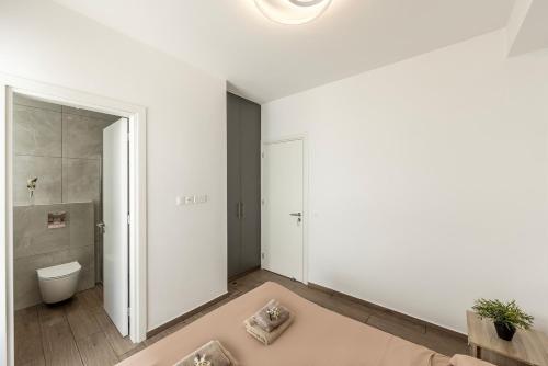a bathroom with a shower and a toilet in it at Seaside Emerald in Paralimni