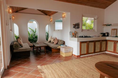 a living room with a couch and a kitchen at 3 Bed Private Villa With Pool, 250m To The Beach in Ahangama