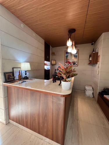 a kitchen with a bar with a potted plant at Urban Haveli in Jaipur