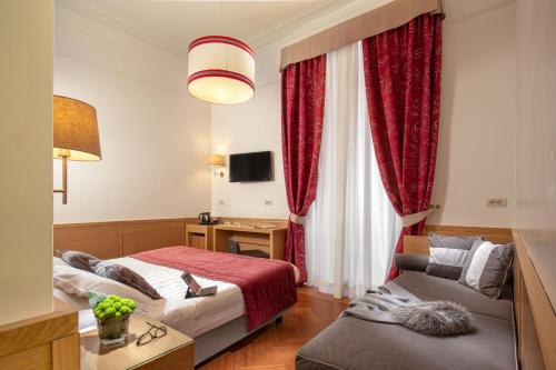two beds in a hotel room with red curtains at Hotel Nord Nuova Roma in Rome