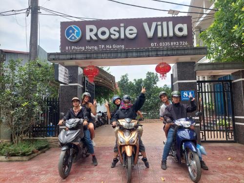 a group of people riding motorcycles in front of a gate at Rosie Villa Ha Giang - Motorbikerental & Tour in Ha Giang