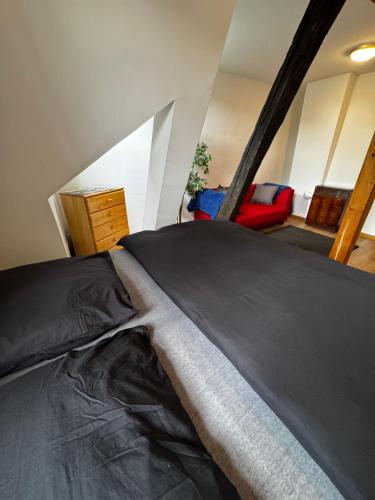 a large bed in a room with a room with at Cozy one-room apartment in Nürnberg