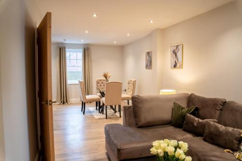a living room with a couch and a table at Cosy 1BR Flat- private parking in Newport