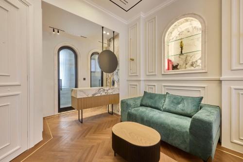 a living room with a couch and a table at Ermou 99 Intelligent Private Suites in Athens