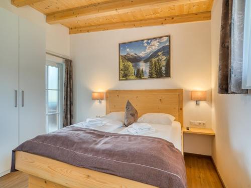 a bedroom with a large bed with a wooden headboard at Apartment building Ferien, Neukirchen in Rosenthal