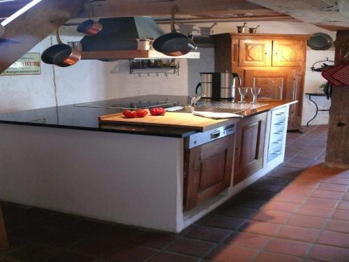 a kitchen with a counter with tomatoes on a cutting board at Guest House near Coast in Wangels
