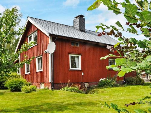 a red house with a green yard at 6 person holiday home in BENGTSFORS-By Traum in Näs
