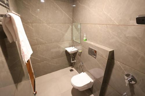 a small bathroom with a toilet and a sink at The Brij Vista in Mathura