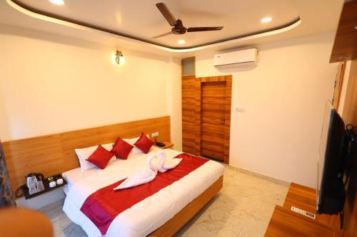 a bedroom with a bed with two white towels on it at The Brij Vista in Mathura