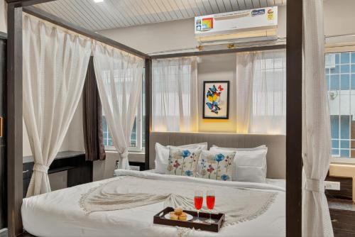 a bedroom with a bed with a tray of food on it at Alaya Stays Lavender Hills Stunning Hillside 3-BHK Villa With Private Pool, Gazebo and Views in Lonavala