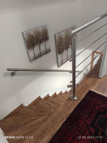 a staircase with a metal rail and a wooden floor at Ferienhaus Familie Zimmermann in Keutschach am See
