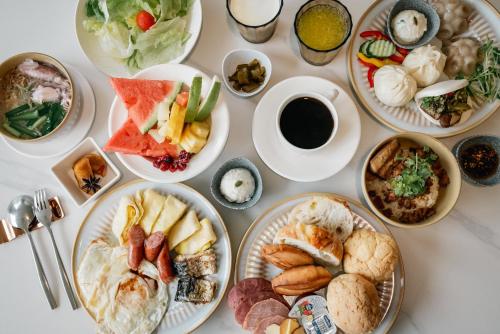 a white table with plates of food on it at Arsma Hotel in Hualien City