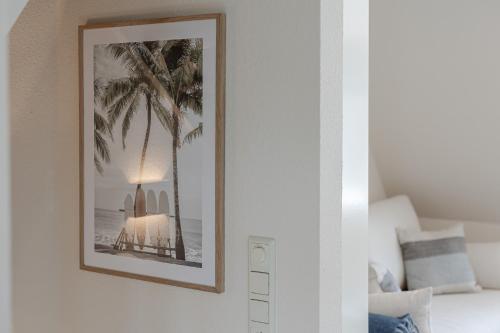 a picture of a bed with a lamp on a wall at Primera in Keitum