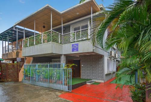 a building with a balcony with a gate at Alaya Stays Lavender Hills Stunning Hillside 3-BHK Villa With Private Pool, Gazebo and Views in Lonavala