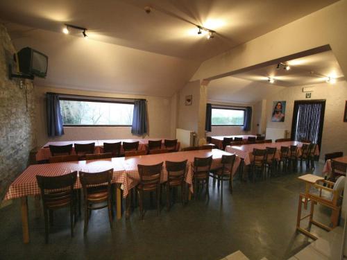 a room with tables and chairs in a restaurant at Grand Family Farmhouse in Anthisnes in Anthisnes